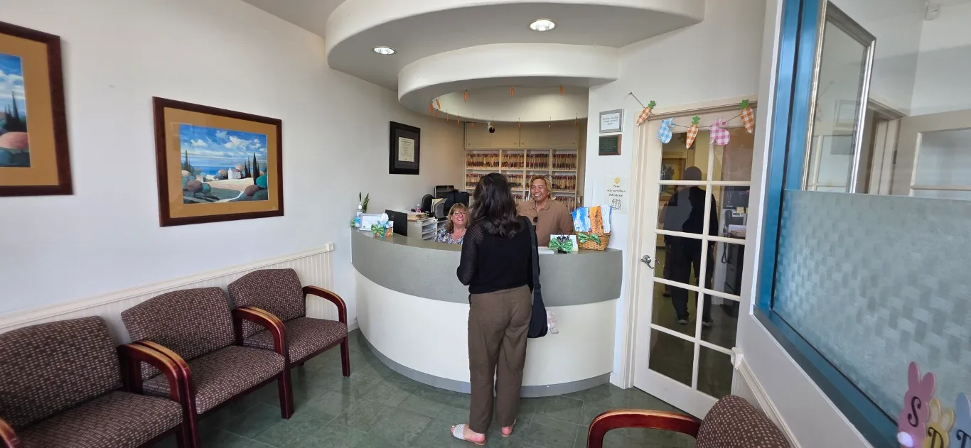 Patient checking in at the front desk of Peninsula Dentistry in Huntington Beach